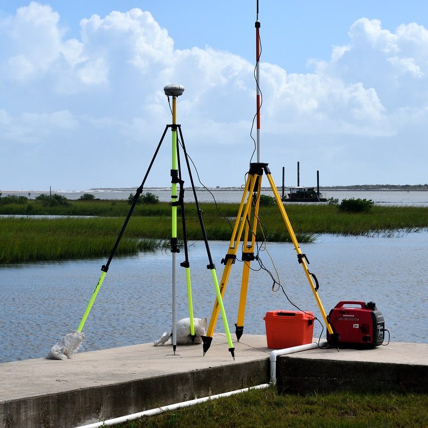 cropped-surveying-equipment-2871066_1280-3.jpg GPS surveying equipment on tripods beside a coastal marsh